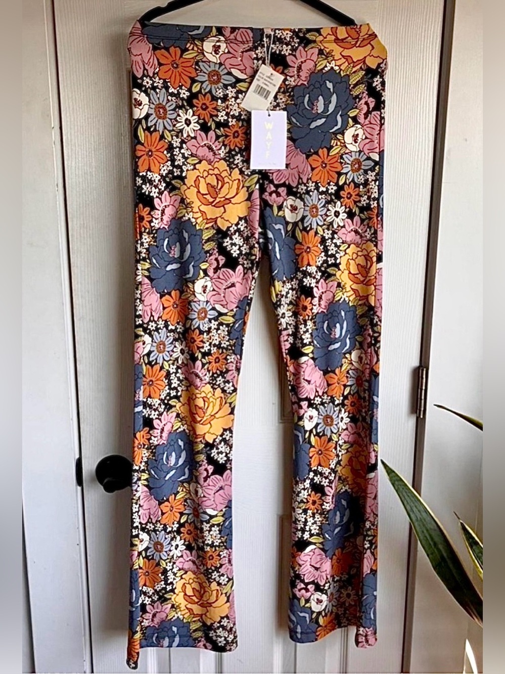 WAYF Decker Flare Leg Pants with 70s-inspired floral pattern